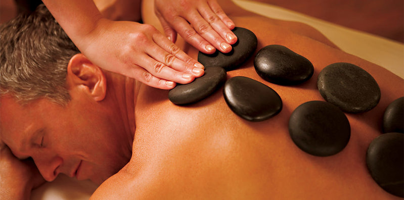 Massagem feita com pedras quentes e frias na massoterapia.